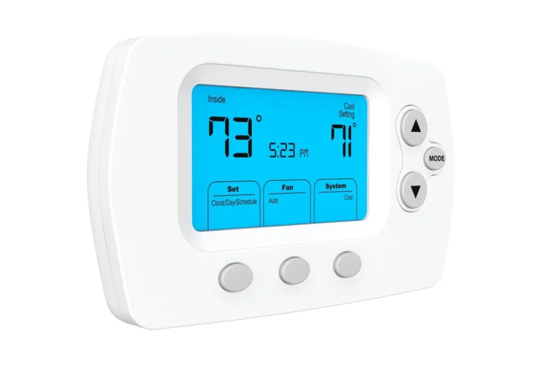 Digital thermostat displaying 73°F inside temperature and 71°F cooling setting. Time reads 5:23 PM. Features include mode, fan, and system control buttons.