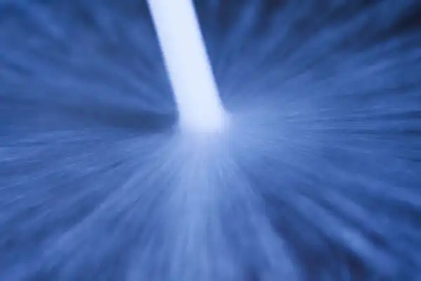 Blue abstract image with a central white streak, suggesting motion or a light beam.